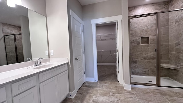 bathroom featuring vanity and a shower with shower door