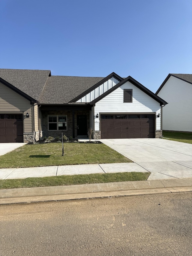 view of front facade with a garage and a front lawn