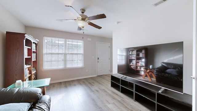 living area featuring ceiling fan and light wood-type flooring