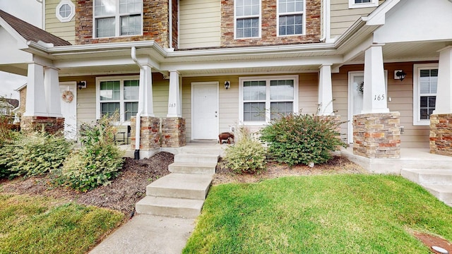 view of exterior entry with covered porch