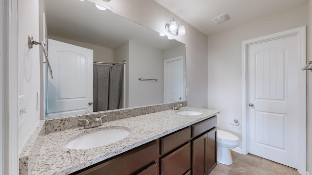 bathroom featuring vanity, a shower, tile patterned floors, and toilet