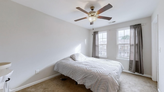 bedroom with ceiling fan and carpet flooring