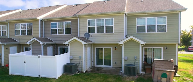 rear view of property with central AC unit