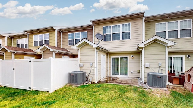 back of house featuring a lawn, a patio area, and central air condition unit