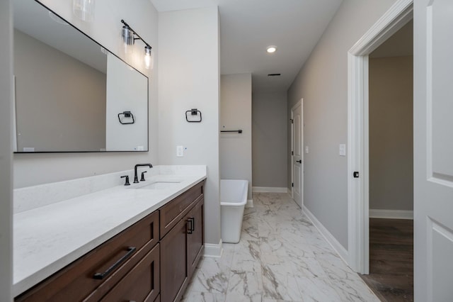 bathroom with vanity and a bathtub