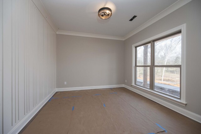 unfurnished room with crown molding