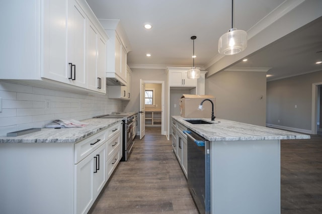 kitchen featuring sink, white cabinetry, hanging light fixtures, appliances with stainless steel finishes, and an island with sink