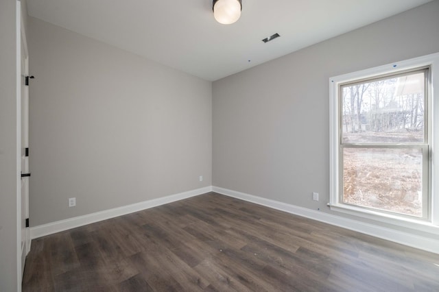 spare room with dark hardwood / wood-style floors