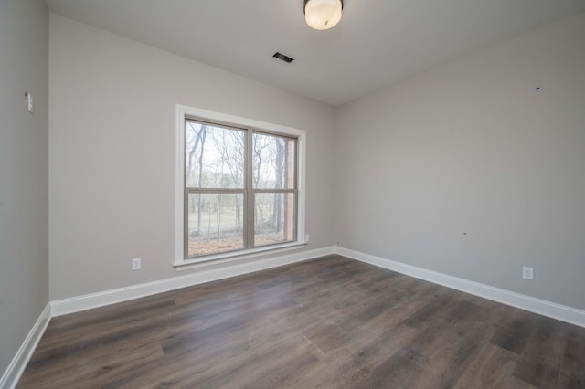 unfurnished room featuring dark hardwood / wood-style floors