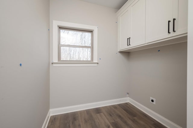 washroom featuring dark hardwood / wood-style flooring, cabinets, and hookup for an electric dryer