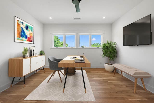 office space with wood-type flooring and ceiling fan