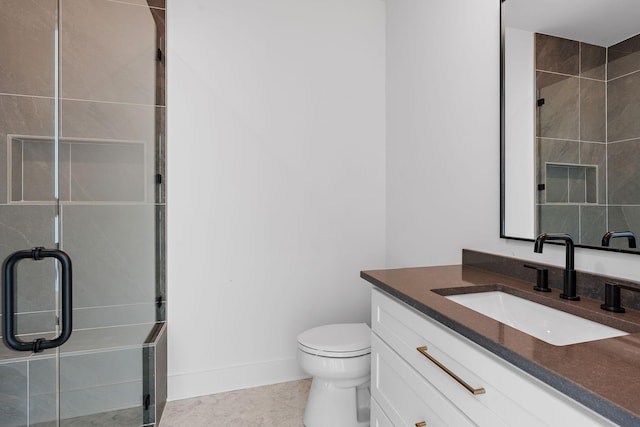 bathroom featuring vanity, walk in shower, and toilet