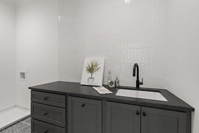 bathroom with sink and tile walls