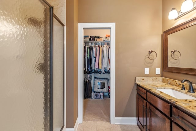 bathroom with vanity and a shower with door