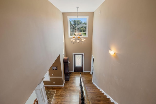 interior space featuring dark hardwood / wood-style flooring and an inviting chandelier