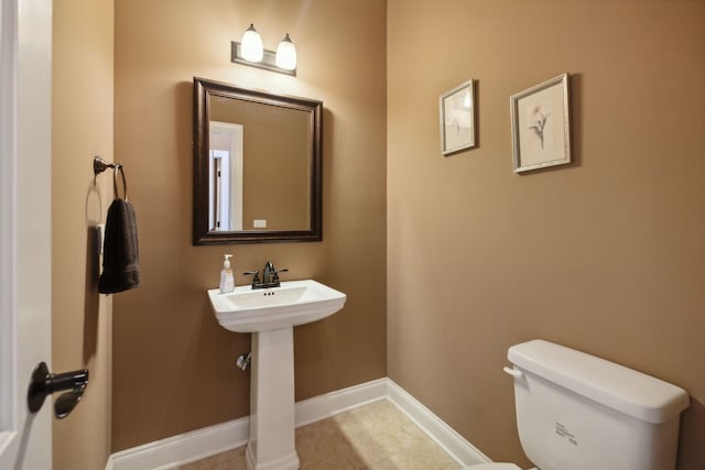 bathroom featuring sink, tile patterned floors, and toilet