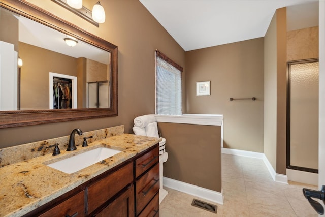 bathroom with vanity, tile patterned flooring, and a shower with door