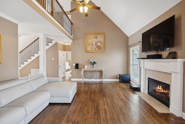 living room with ceiling fan, high vaulted ceiling, hardwood / wood-style floors, and a fireplace