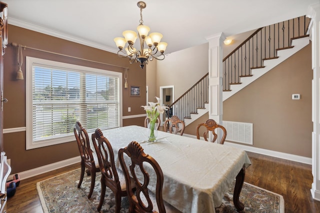 dining area with a notable chandelier, crown molding, and dark hardwood / wood-style floors