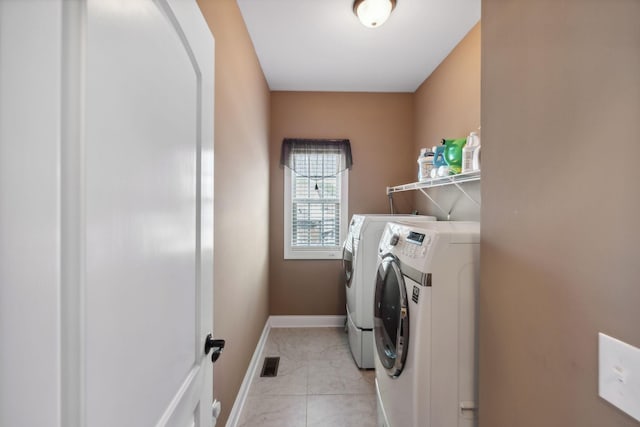 laundry room with separate washer and dryer and light tile patterned floors