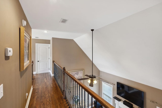 corridor with lofted ceiling and dark hardwood / wood-style flooring