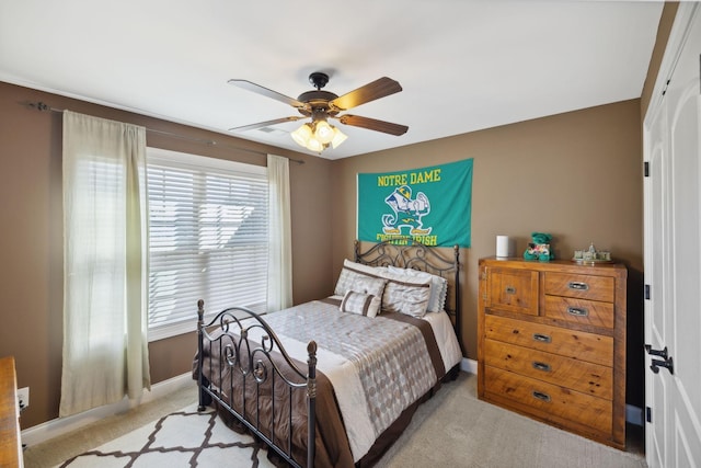 bedroom featuring light colored carpet and ceiling fan