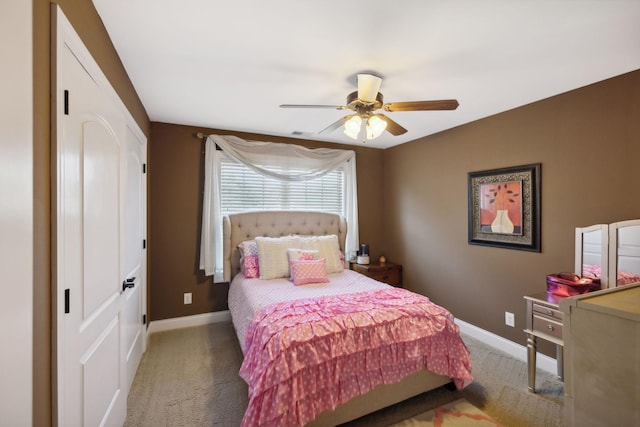 bedroom featuring ceiling fan and dark carpet