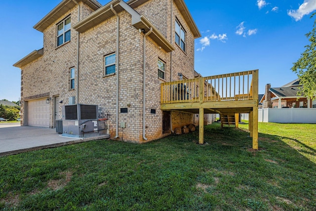 view of side of home with a garage, a deck, and a lawn