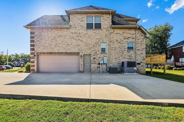 exterior space featuring central AC, a garage, and a deck