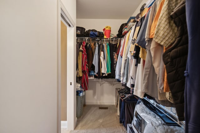 spacious closet featuring light carpet