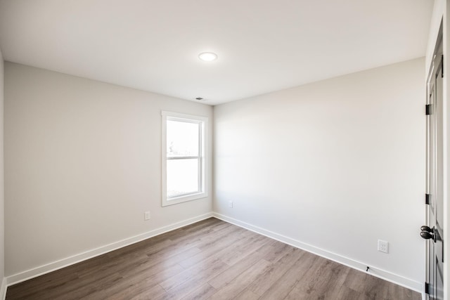 unfurnished room with light wood-type flooring