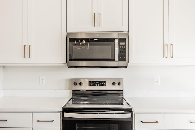 kitchen with white cabinetry and stainless steel appliances