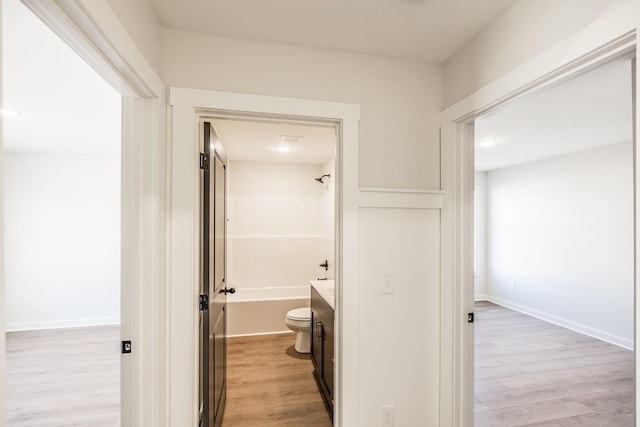 full bathroom with vanity, wood-type flooring, bathtub / shower combination, and toilet