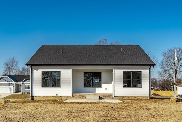 rear view of house featuring a yard