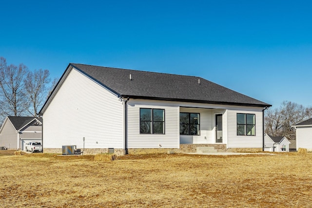 back of house featuring a yard and central air condition unit