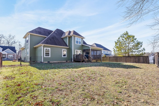 back of house featuring a deck and a lawn