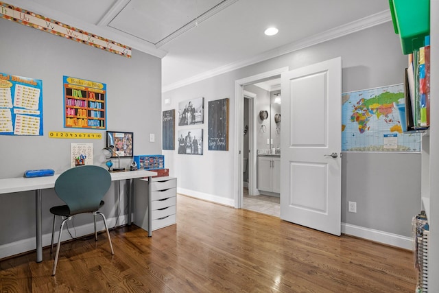 home office with crown molding and hardwood / wood-style floors