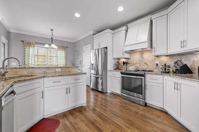 kitchen featuring custom exhaust hood, sink, white cabinets, and stainless steel appliances