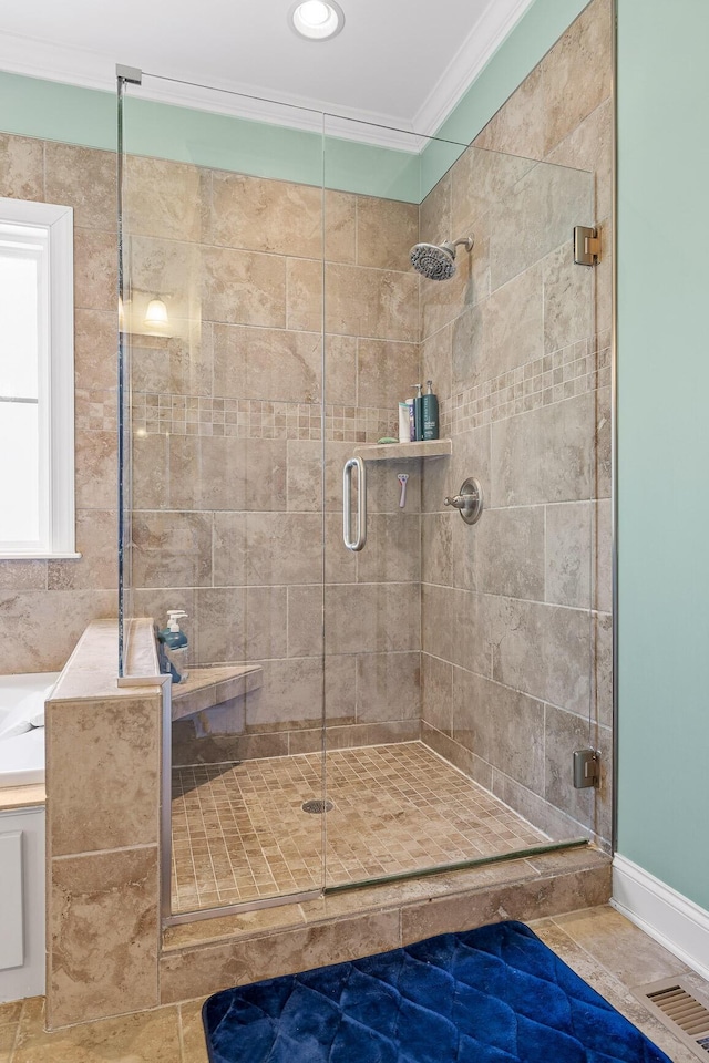 bathroom with ornamental molding and a shower with shower door