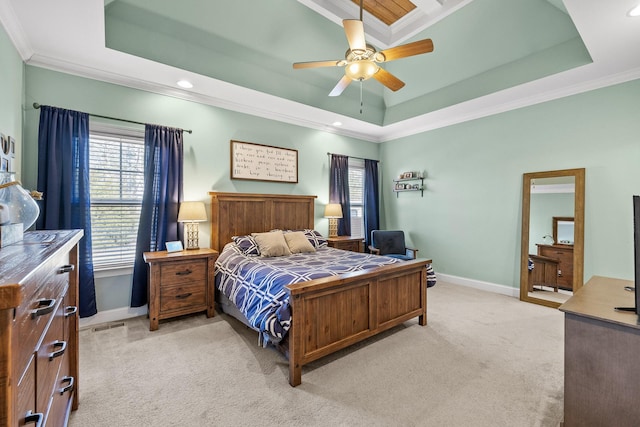 carpeted bedroom featuring crown molding, ceiling fan, and a tray ceiling