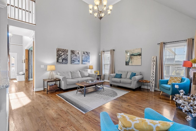 living room featuring a high ceiling, hardwood / wood-style floors, and a chandelier