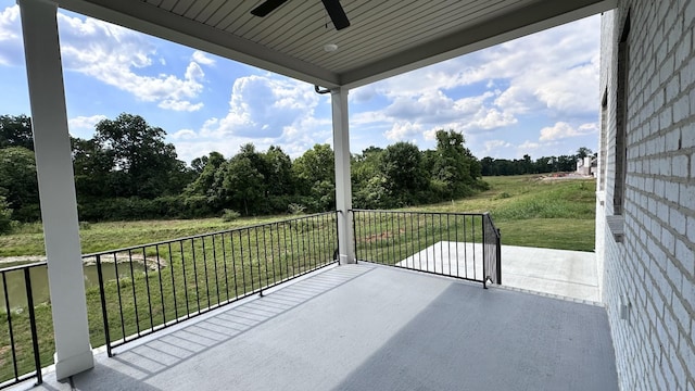 view of patio with a balcony and ceiling fan