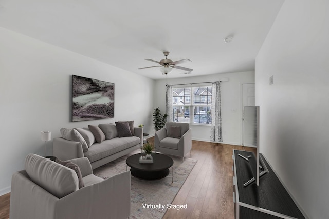 living room featuring dark hardwood / wood-style flooring and ceiling fan