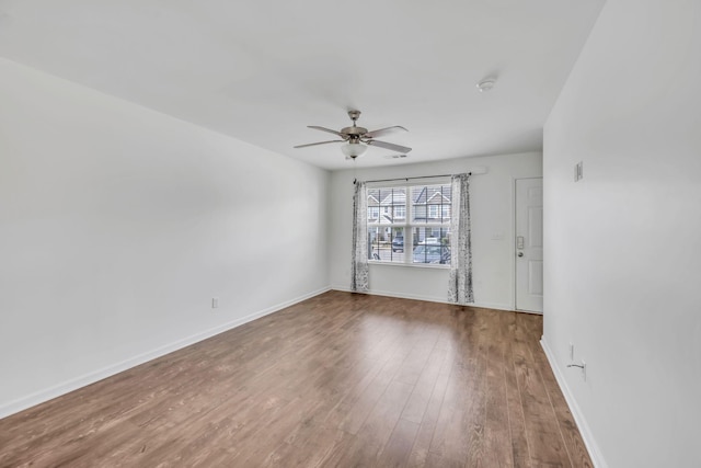 empty room featuring hardwood / wood-style flooring and ceiling fan