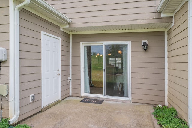 view of exterior entry featuring a patio area