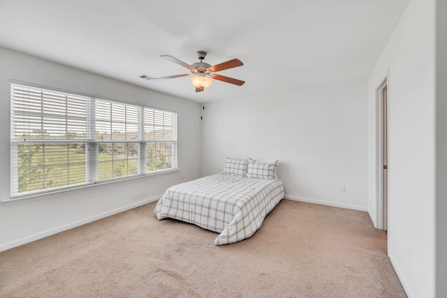 bedroom featuring ceiling fan and light colored carpet