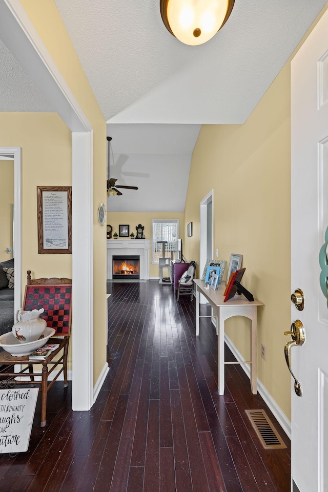 corridor featuring hardwood / wood-style flooring and lofted ceiling