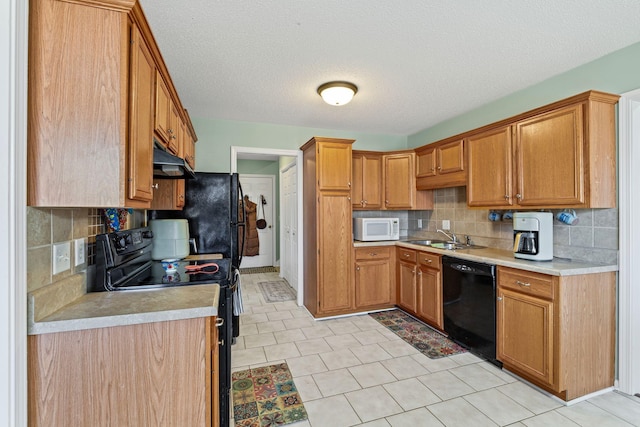 kitchen with ventilation hood, sink, backsplash, and black appliances