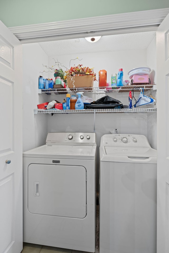 clothes washing area with washing machine and clothes dryer