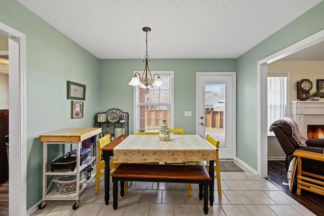 dining space featuring a notable chandelier and a textured ceiling